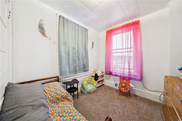 a bedroom with furniture and a window