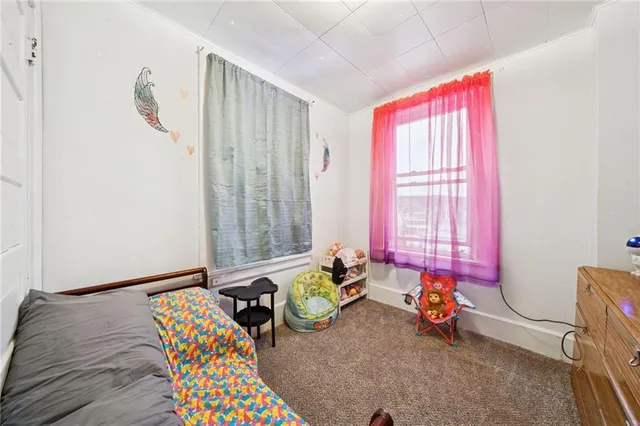 a bedroom with furniture and a window