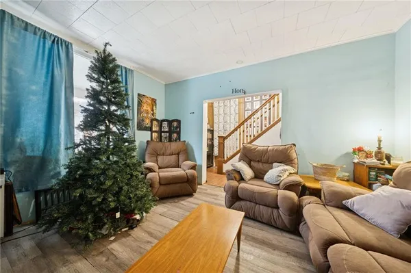 a living room with furniture plant and a window