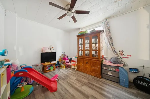 a bedroom with furniture and a wooden floor