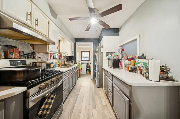 a kitchen with lots of counter top space and stainless steel appliances
