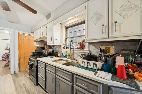a kitchen with stainless steel appliances granite countertop a sink and cabinets