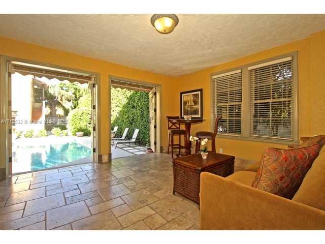 2330 Prairie Avenue Miami Beach, FL 33140 - Photo 8 of 25 a living room with furniture and a floor to ceiling window