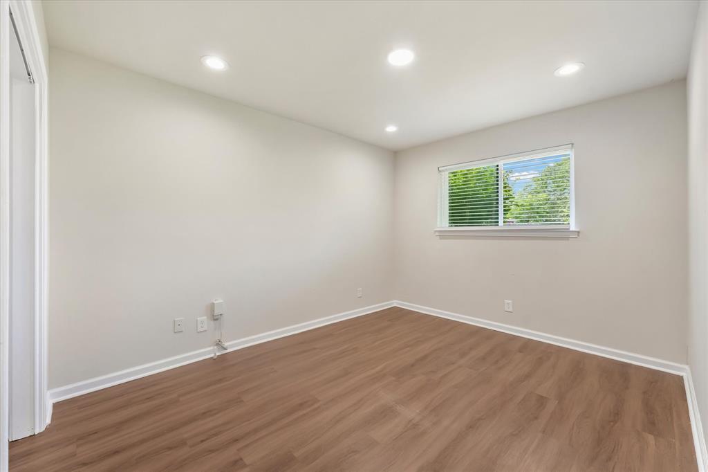 304 East Stone Road Wylie, TX 75098 - Photo 11 of 19 an empty room with wooden floor and windows