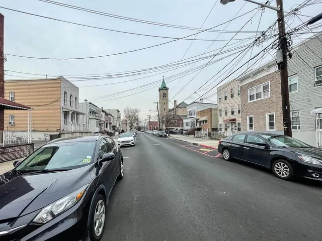 a couple of cars parked in front of a building