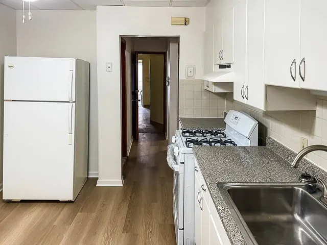 a kitchen with a refrigerator and a stove