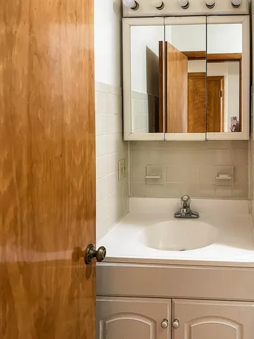 a bathroom with a sink and a mirror