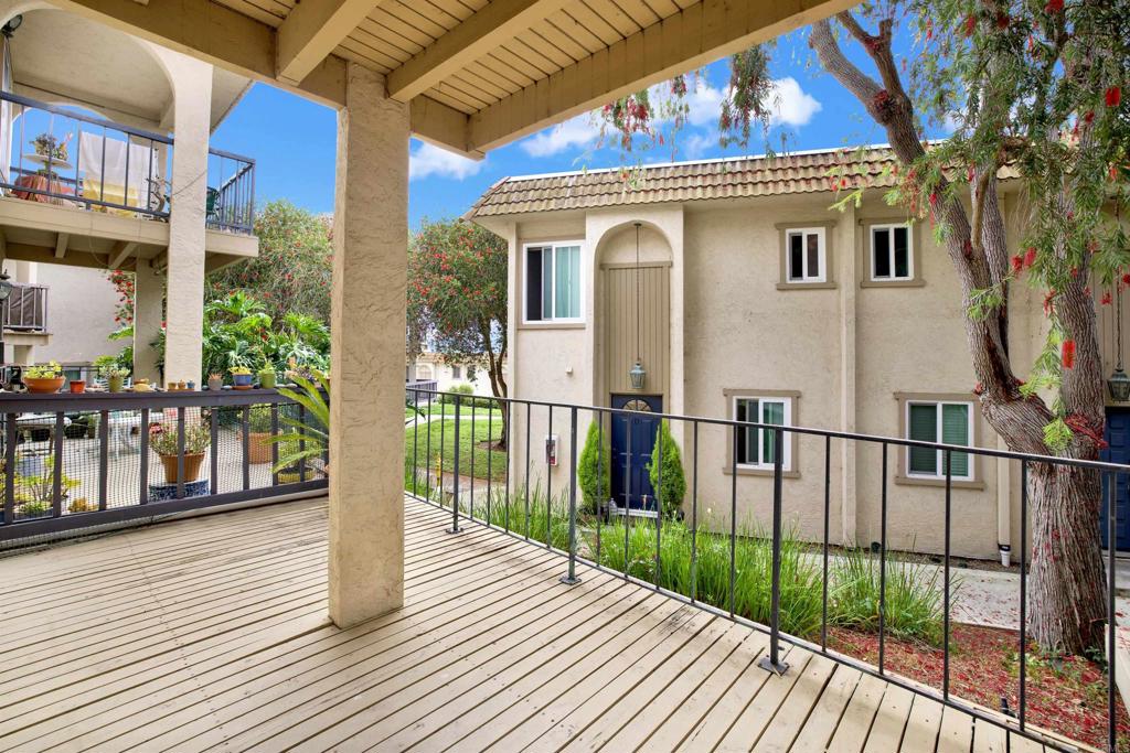 2383 Altisma Way, Unit D Carlsbad, CA 92009 - Photo 13 of 40 a view of a house with large windows and plants