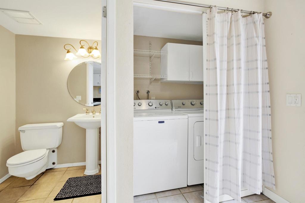 2383 Altisma Way, Unit D Carlsbad, CA 92009 - Photo 16 of 40 a bathroom with a toilet and a shower curtain