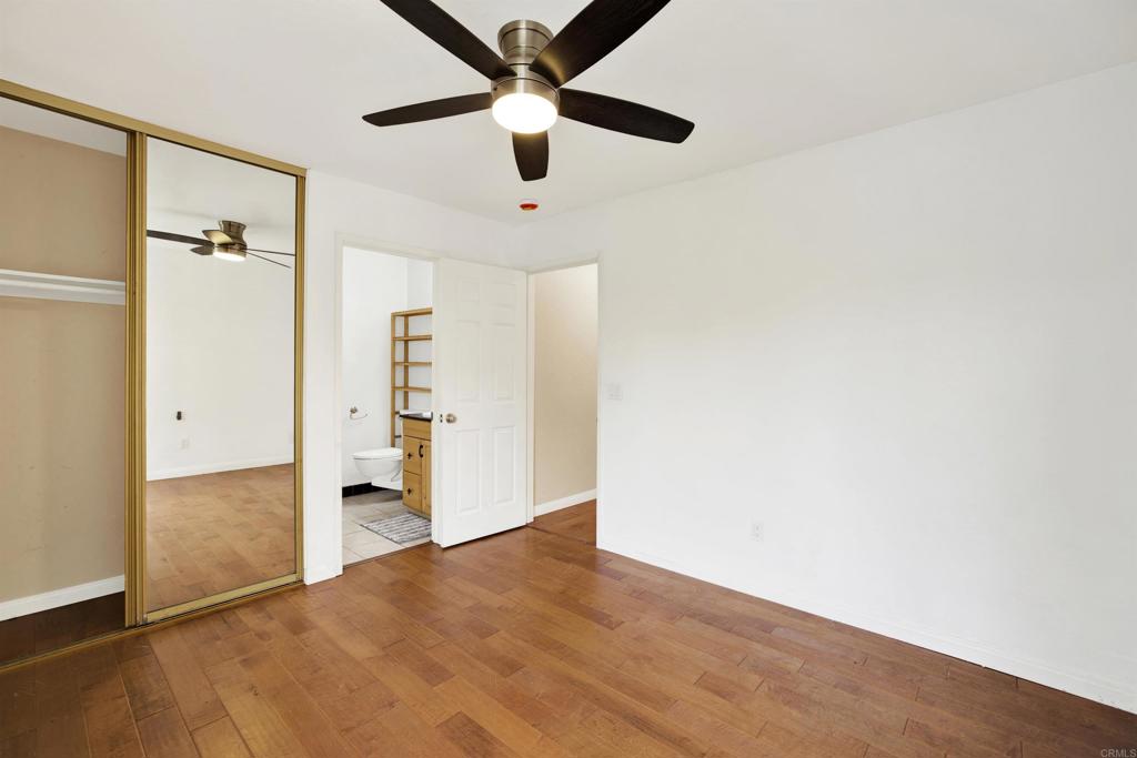 2383 Altisma Way, Unit D Carlsbad, CA 92009 - Photo 19 of 40 an empty room with closet and a ceiling fan