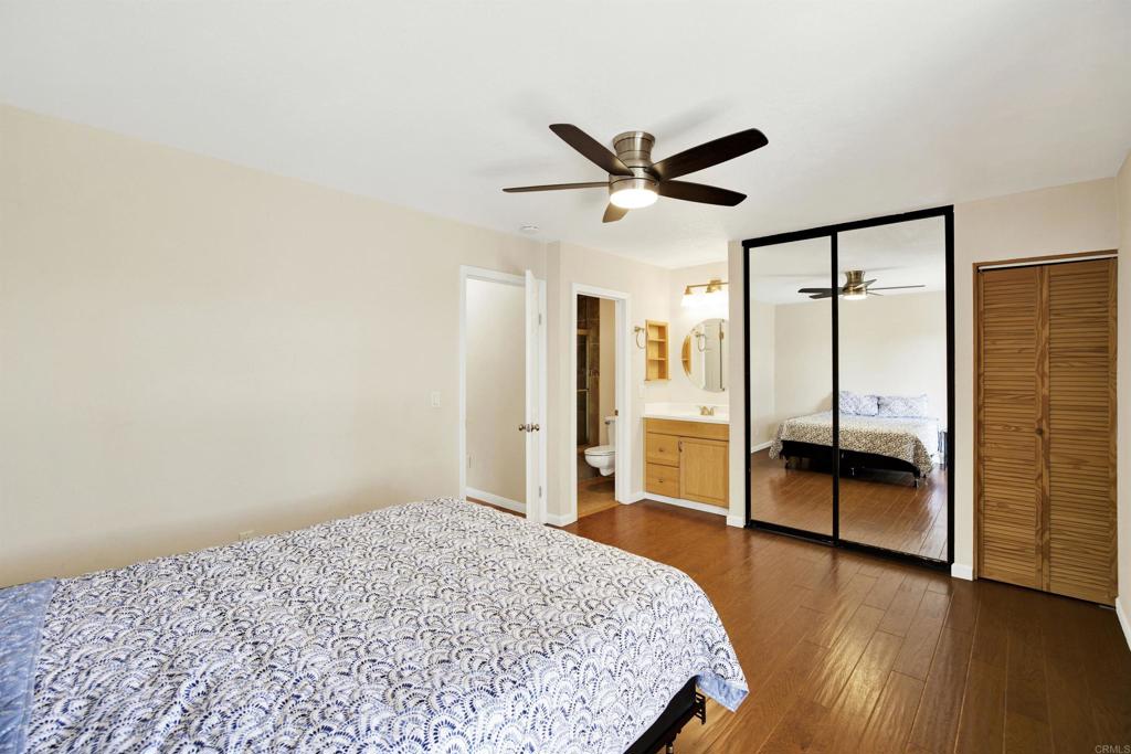 2383 Altisma Way, Unit D Carlsbad, CA 92009 - Photo 23 of 40 a bedroom with a bed and a chandelier