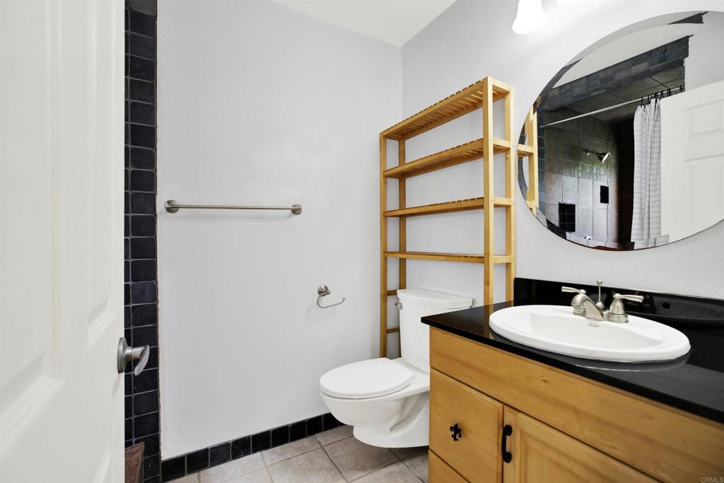 2383 Altisma Way, Unit D Carlsbad, CA 92009 - Photo 25 of 40 a bathroom with a sink a toilet and shower