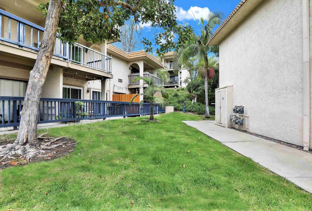 2383 Altisma Way, Unit D Carlsbad, CA 92009 - Photo 39 of 40 a front view of a house with a yard and porch