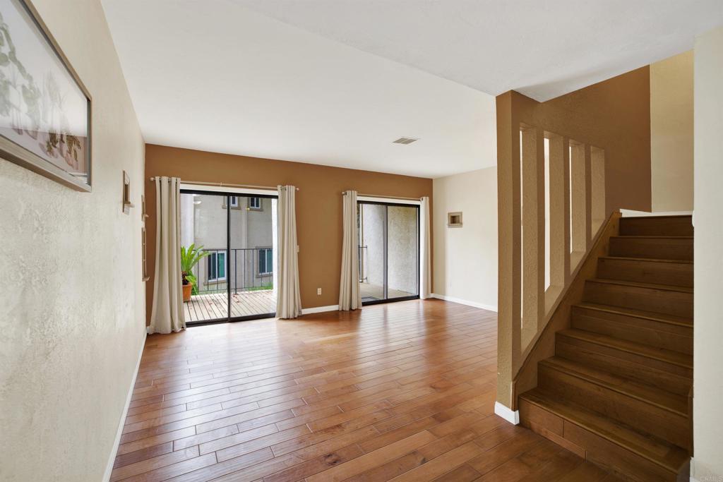2383 Altisma Way, Unit D Carlsbad, CA 92009 - Photo 8 of 40 a view of an entryway with wooden floor and door