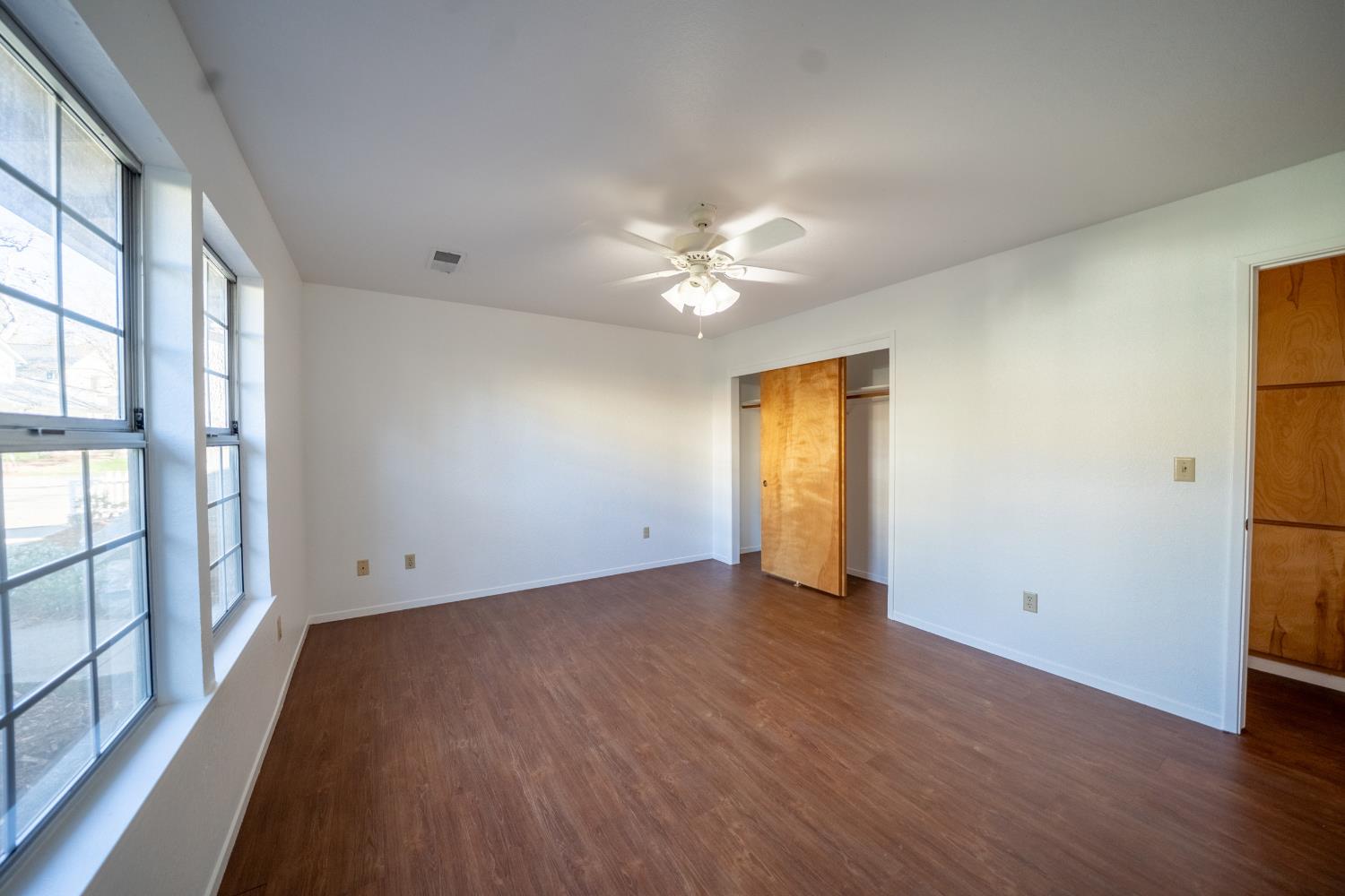 494 Surrey Court Murphys, CA 95247 - Photo 38 of 76 wooden floor in an empty room with a window