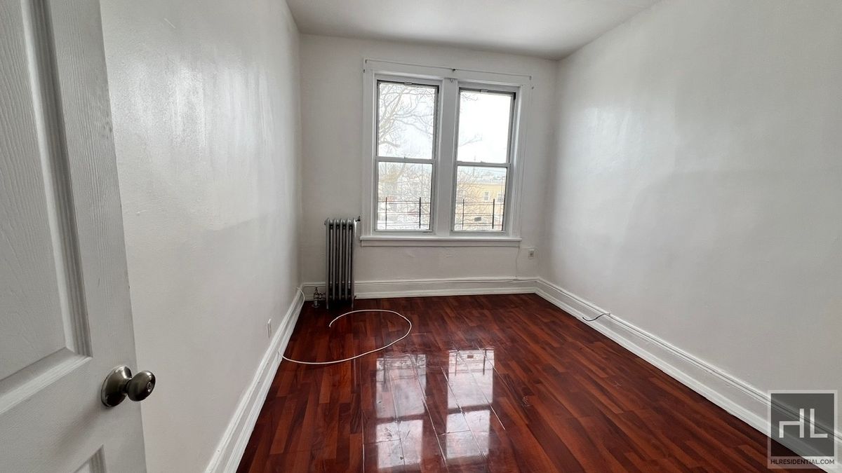 1269 Remsen Avenue, Unit 2 Brooklyn, NY 11236 - Photo 11 of 22 an empty room with wooden floor and windows