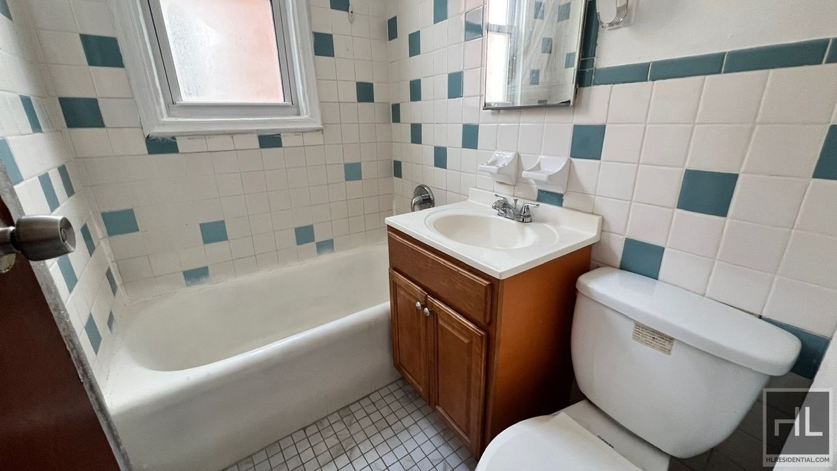 1269 Remsen Avenue, Unit 2 Brooklyn, NY 11236 - Photo 12 of 22 a bathroom with a sink toilet vanity and bathtub