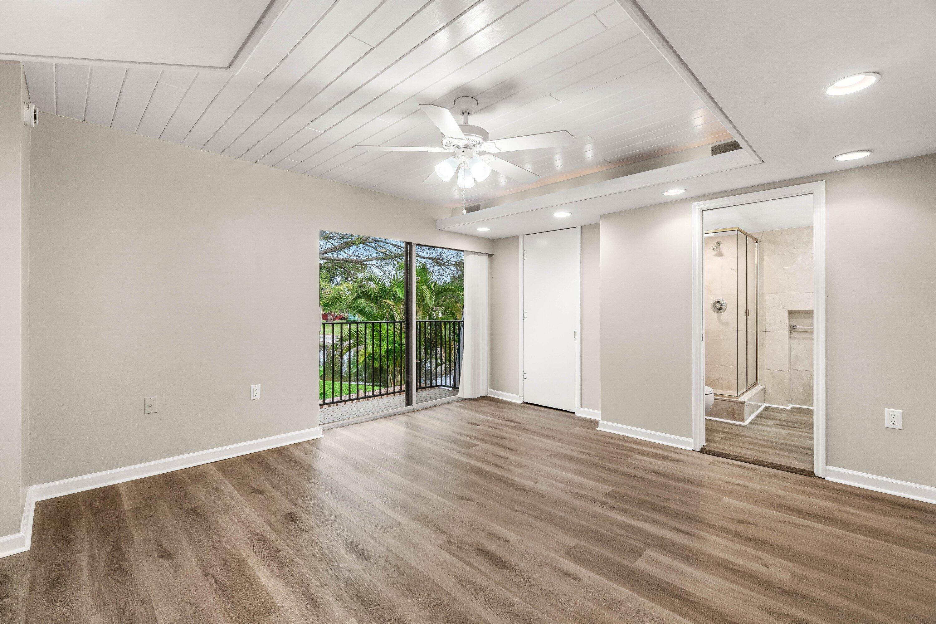 2905 Southwest 22nd Circle, Unit 40A Delray Beach, FL 33445 - Photo 13 of 38 wooden floor in an empty room with a window