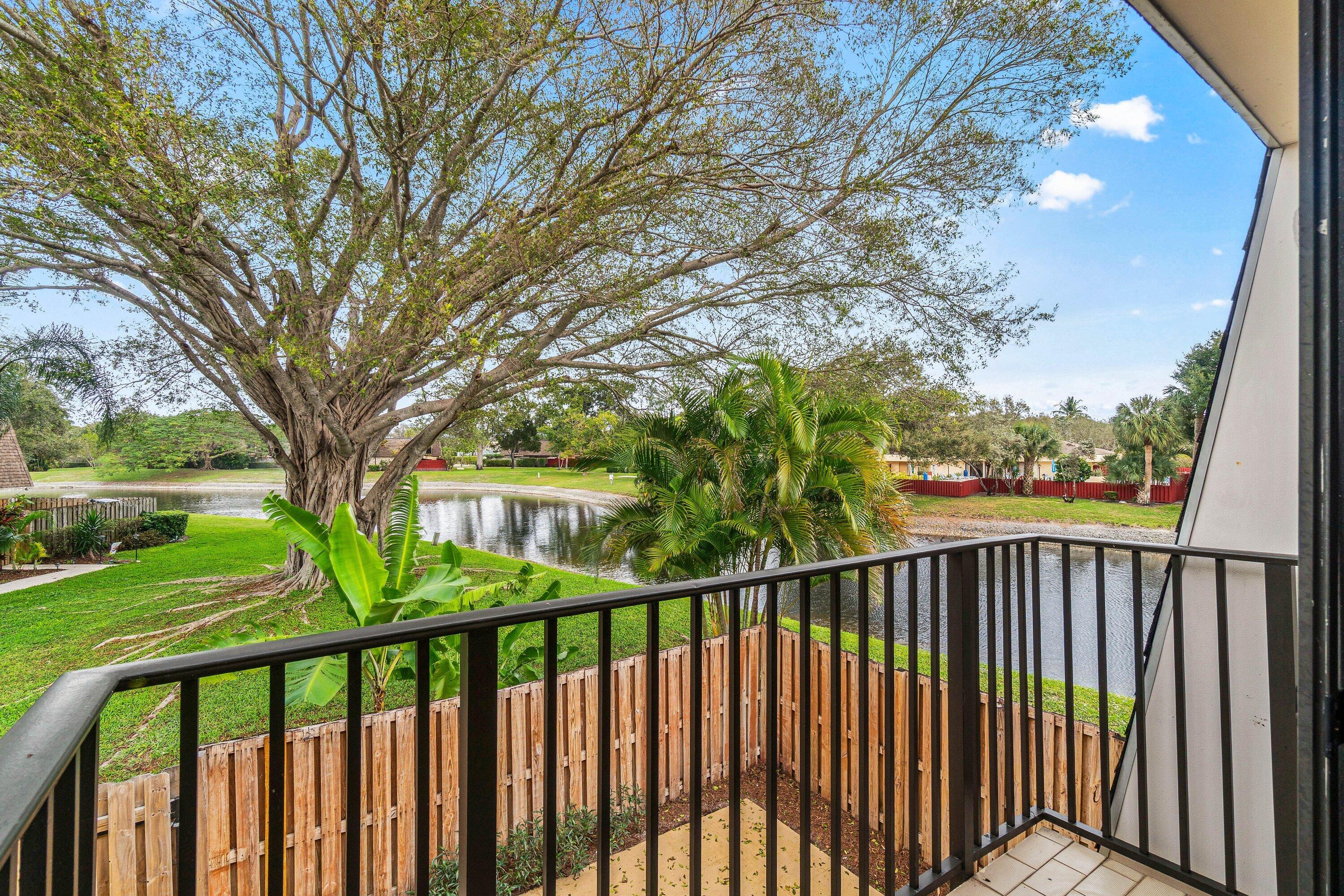 2905 Southwest 22nd Circle, Unit 40A Delray Beach, FL 33445 - Photo 18 of 38 a view of a balcony with trees