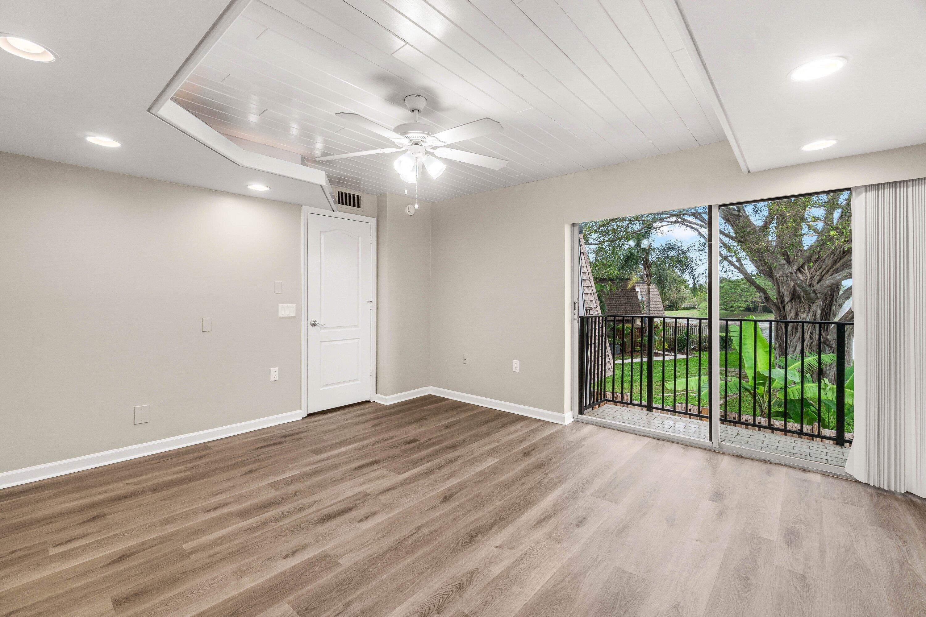 2905 Southwest 22nd Circle, Unit 40A Delray Beach, FL 33445 - Photo 20 of 38 a view of an empty room with wooden floor and a ceiling fan