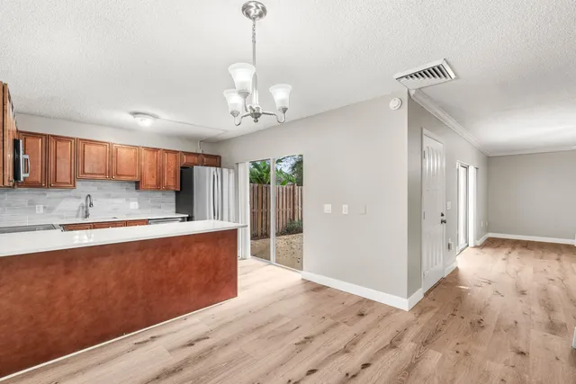 a view of a kitchen with stainless steel appliances granite countertop cabinets and wooden floor