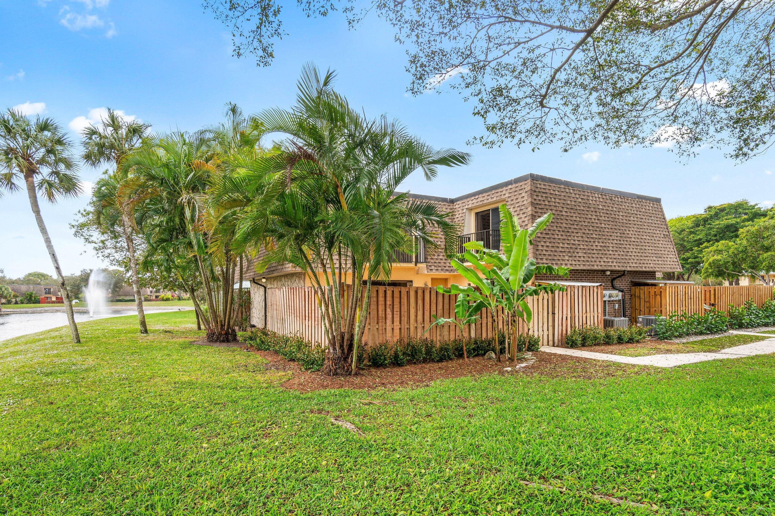 2905 Southwest 22nd Circle, Unit 40A Delray Beach, FL 33445 - Photo 32 of 38 a front view of a house with garden