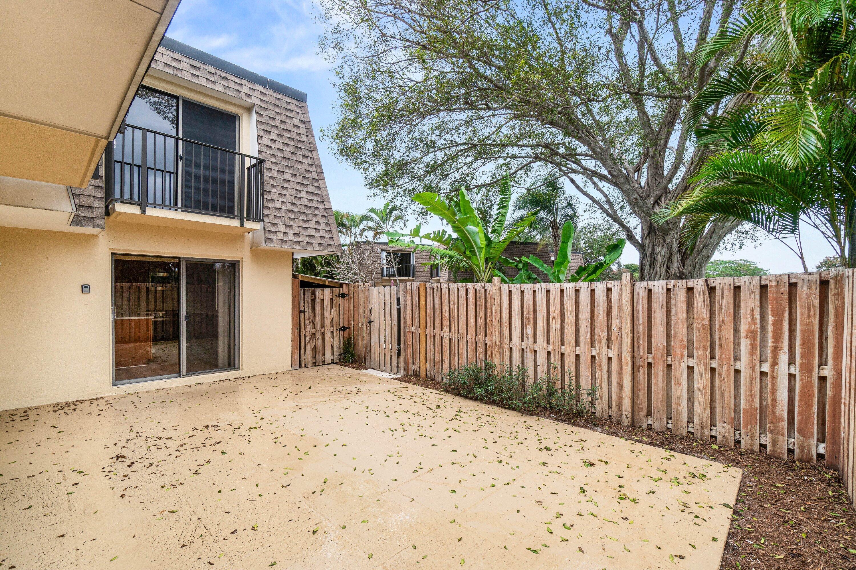 2905 Southwest 22nd Circle, Unit 40A Delray Beach, FL 33445 - Photo 35 of 38 a front view of a house with a large tree