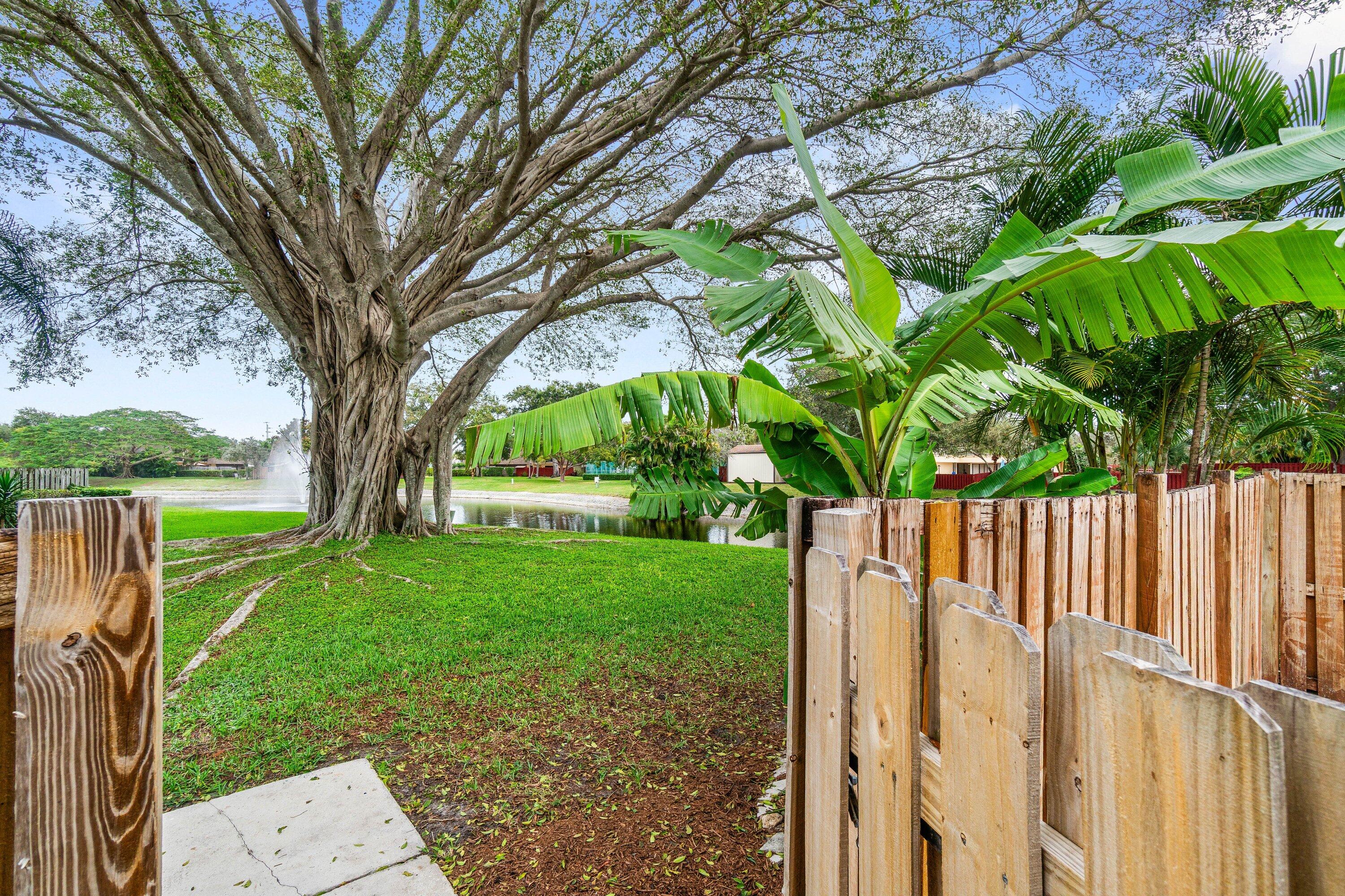 2905 Southwest 22nd Circle, Unit 40A Delray Beach, FL 33445 - Photo 37 of 38 a view of a yard with a tree