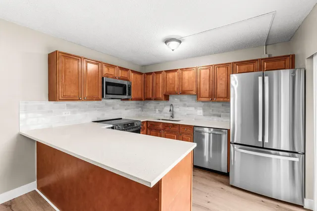 a kitchen with a refrigerator sink and microwave