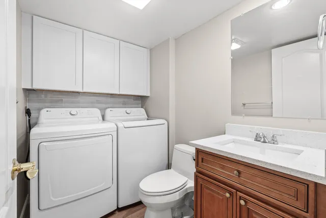 a bathroom with a toilet sink and mirror