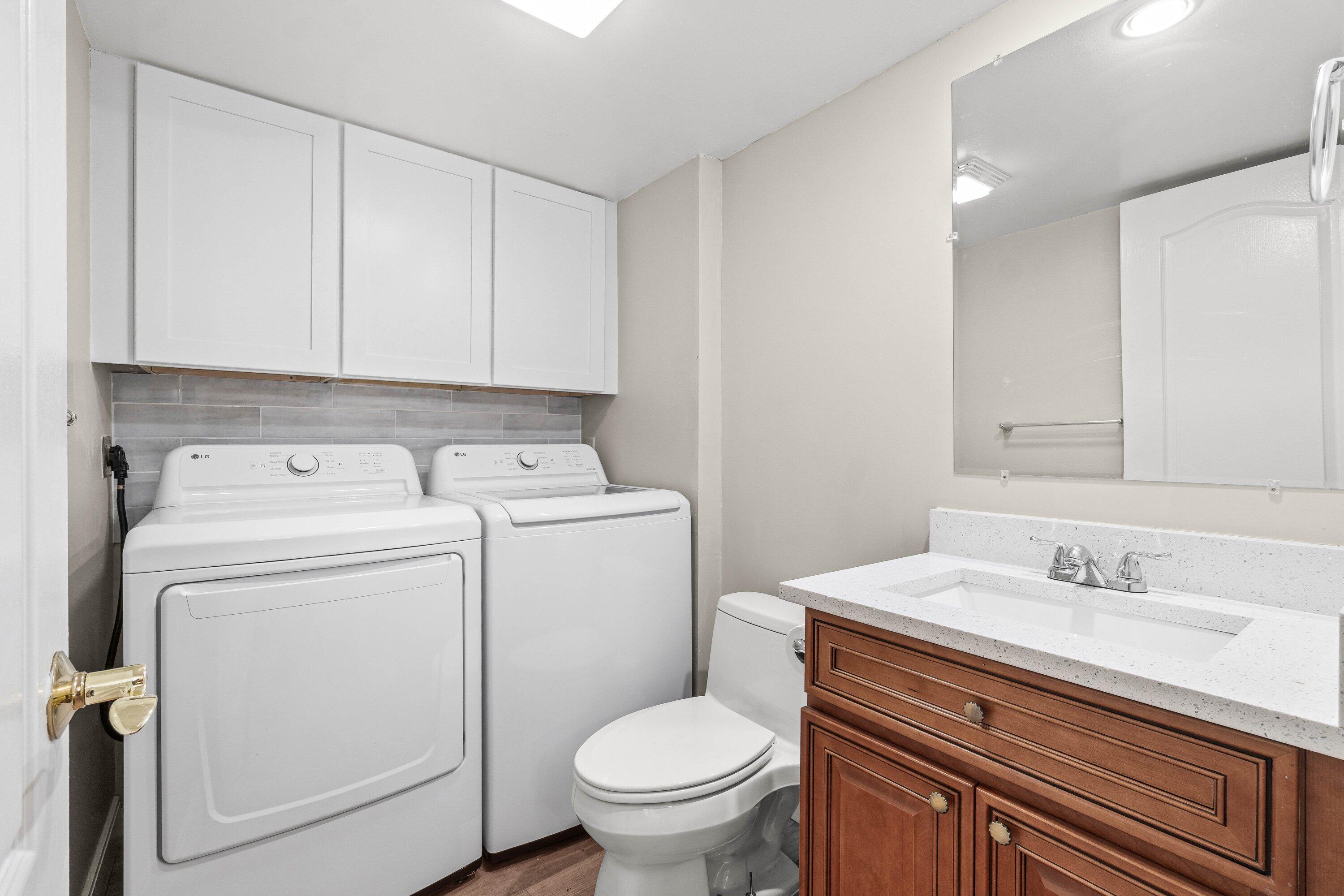 2905 Southwest 22nd Circle, Unit 40A Delray Beach, FL 33445 - Photo 8 of 38 a bathroom with a toilet sink and mirror