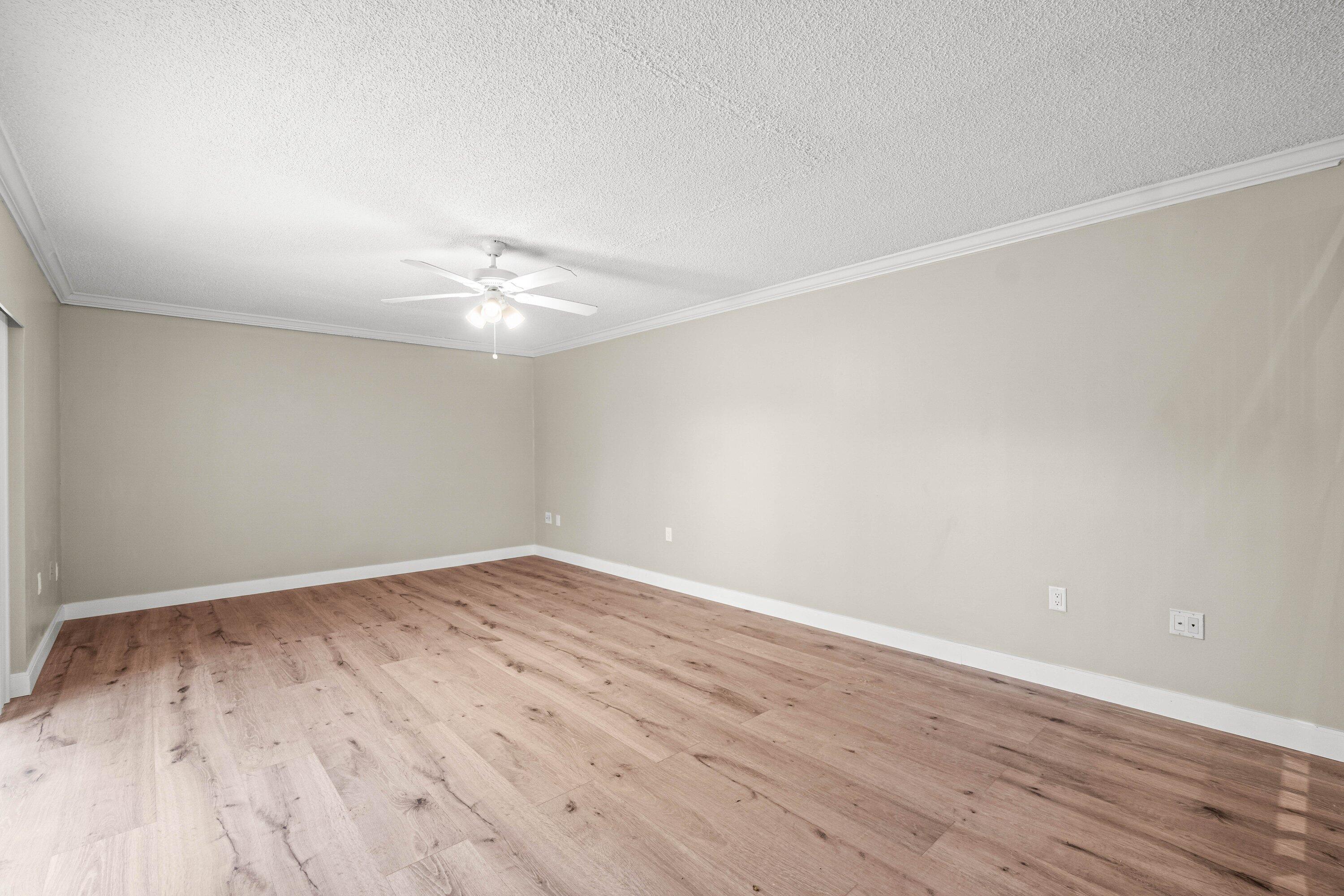 2905 Southwest 22nd Circle, Unit 40A Delray Beach, FL 33445 - Photo 9 of 38 wooden floor in a empty room