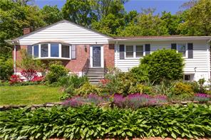 83 Edgemont Road Scarsdale, NY 10583 - Photo 1 of 1 a front view of a house with a yard and fountain