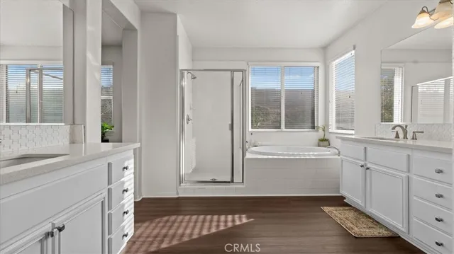 a bathroom with a tub sink and mirror
