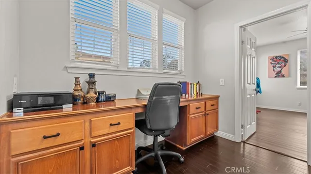 a kitchen with stainless steel appliances granite countertop a stove a sink and a refrigerator with wooden floors