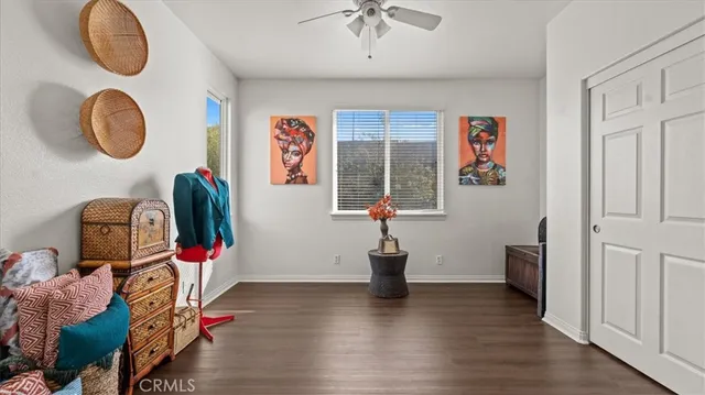wooden floor with white cabinet a sink and a mirror