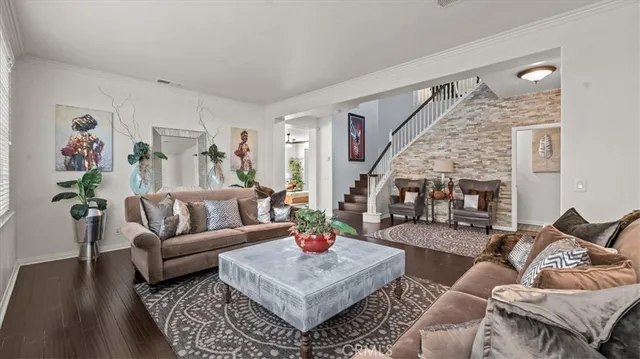 a living room with furniture or couch and a wooden floor