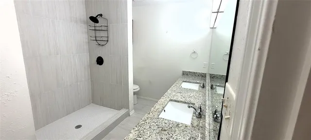 a bathroom with a glass shower door