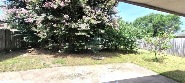 a view of a wooden house with a yard