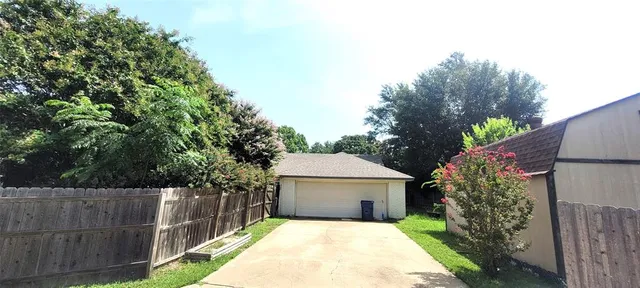 a white house that has tree in front of it