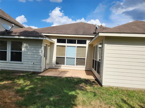 a view of house with backyard and garden