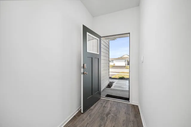 a view of a room with wooden floor