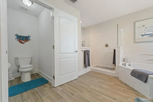 a living room with a bed furniture and a flat screen tv