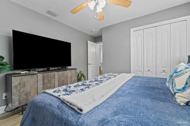 a bathroom with a granite countertop sink a toilet and a mirror