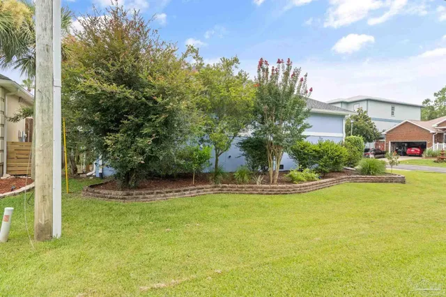 an aerial view of a house with big yard