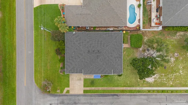an aerial view of a house with a garden and lake view