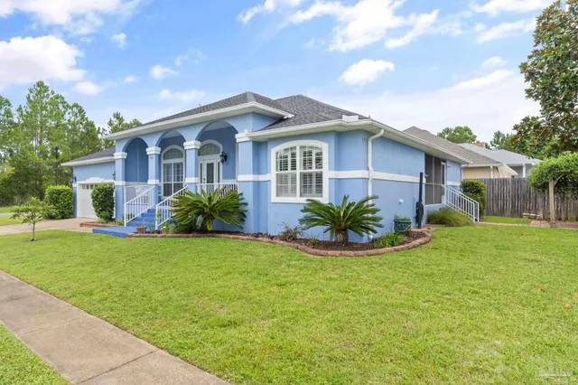 a front view of house with yard and green space