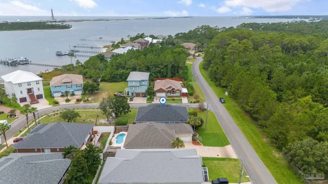a balcony with wooden floor and trees in the background