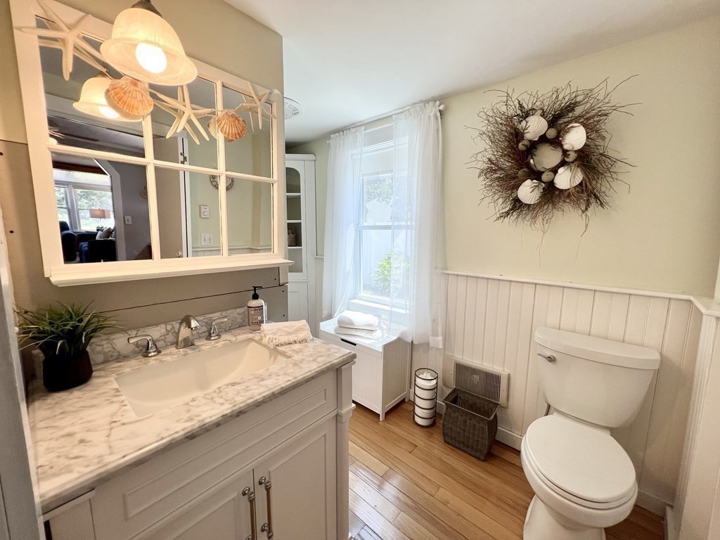 135 Balsam Street Fairhaven, MA 02719 - Photo 14 of 39 a bathroom with a granite countertop sink a toilet and a mirror