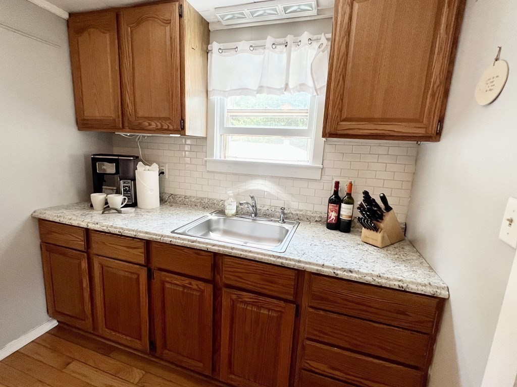 135 Balsam Street Fairhaven, MA 02719 - Photo 15 of 39 a kitchen with granite countertop stainless steel appliances a sink window and cabinets